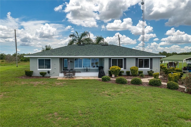 back of house featuring a lawn and a patio area