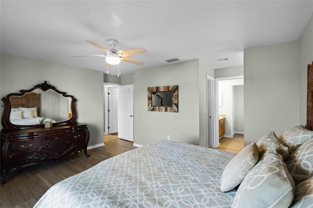 bedroom featuring ensuite bathroom, ceiling fan, and dark hardwood / wood-style flooring