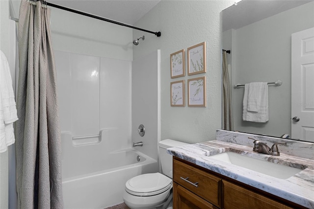 full bathroom with vanity, shower / tub combo, and toilet