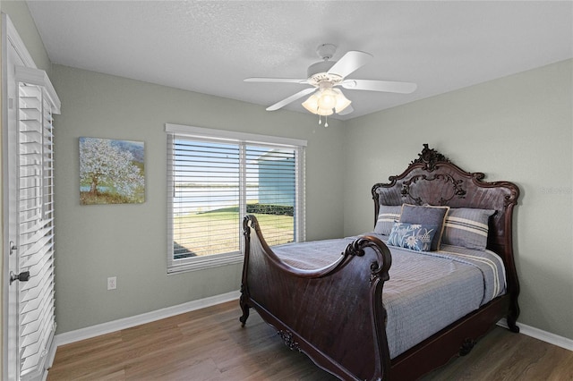 bedroom featuring ceiling fan and wood-type flooring