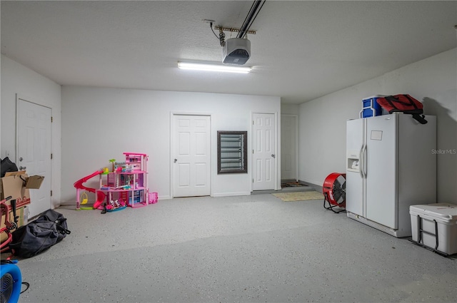 garage with white fridge with ice dispenser and a garage door opener