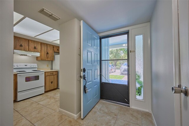 kitchen featuring light tile patterned flooring and white appliances