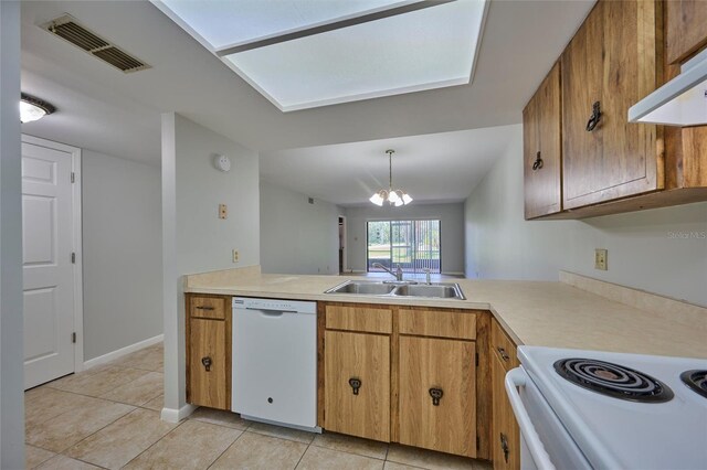 kitchen featuring white appliances, sink, pendant lighting, light tile patterned floors, and a chandelier