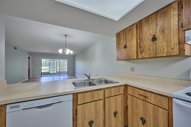 kitchen with sink, pendant lighting, a chandelier, and white appliances