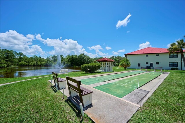 view of property's community featuring a water view and a lawn