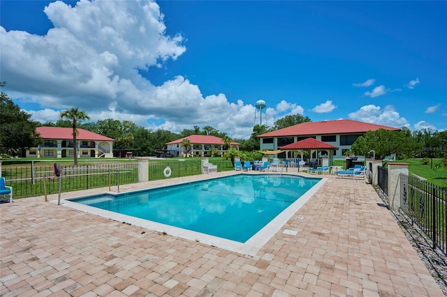 view of pool featuring a yard and a patio