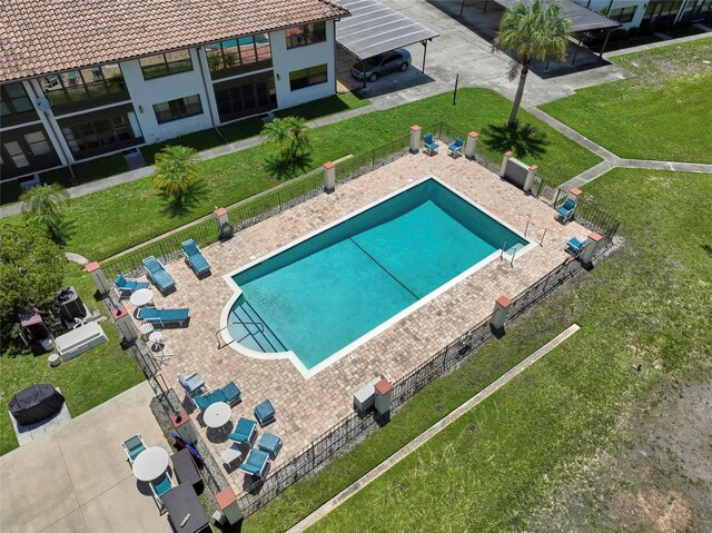 view of pool featuring a patio area and a yard