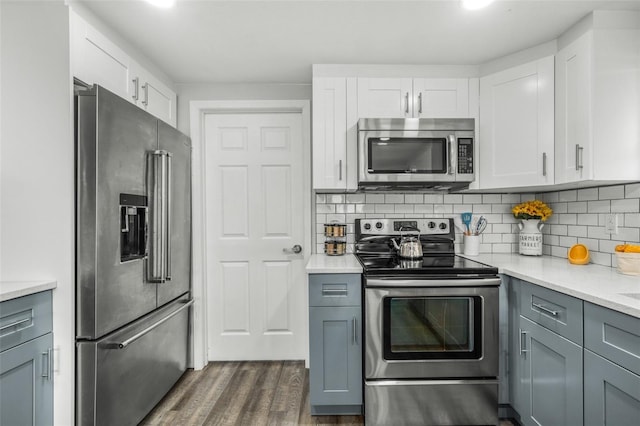 kitchen featuring white cabinets, gray cabinets, and appliances with stainless steel finishes