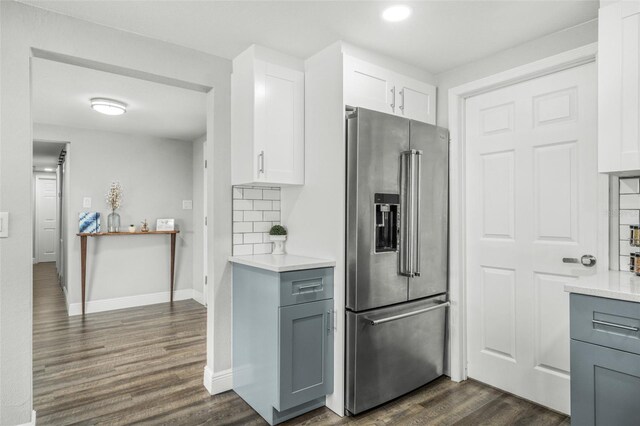 kitchen with white cabinetry, stainless steel fridge with ice dispenser, dark hardwood / wood-style floors, backsplash, and gray cabinets