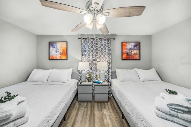 bedroom with ceiling fan and dark wood-type flooring