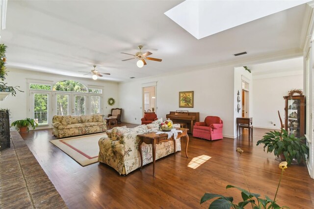 living room with ceiling fan, crown molding, and dark wood-type flooring