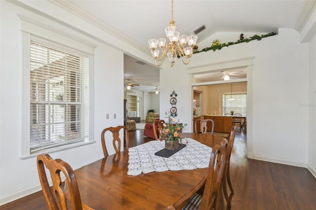 dining area featuring ornamental molding, vaulted ceiling, ceiling fan with notable chandelier, and dark hardwood / wood-style floors