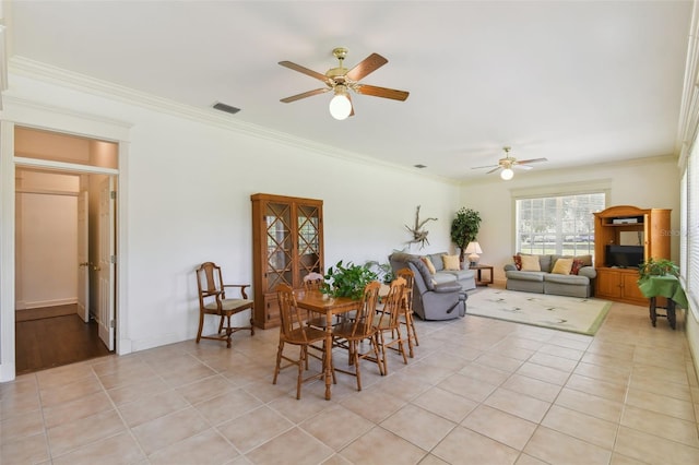 tiled living room featuring crown molding and ceiling fan