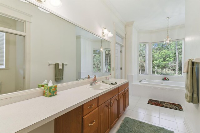 bathroom with vanity, crown molding, tile patterned floors, and a tub