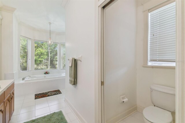 bathroom with vanity, tile patterned floors, toilet, and a bathtub