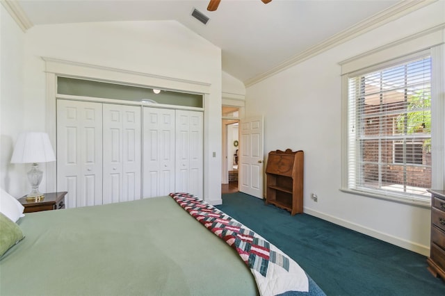 bedroom featuring a closet, vaulted ceiling, dark carpet, crown molding, and ceiling fan