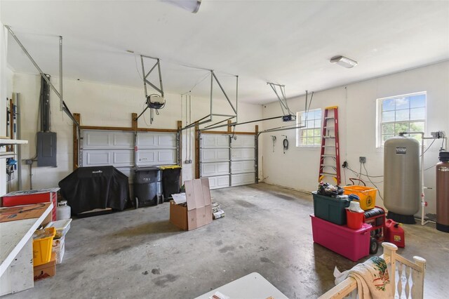 garage with a garage door opener and electric panel