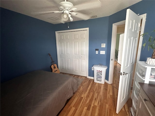 bedroom with ceiling fan, hardwood / wood-style floors, and a closet