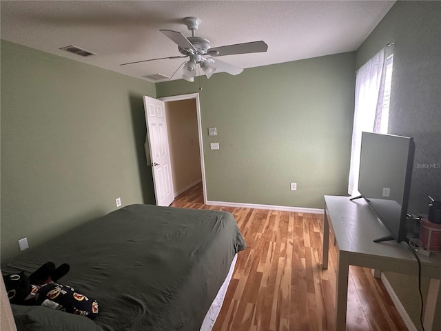 bedroom featuring ceiling fan and hardwood / wood-style flooring