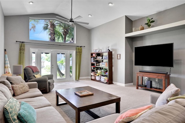 carpeted living room featuring vaulted ceiling and french doors