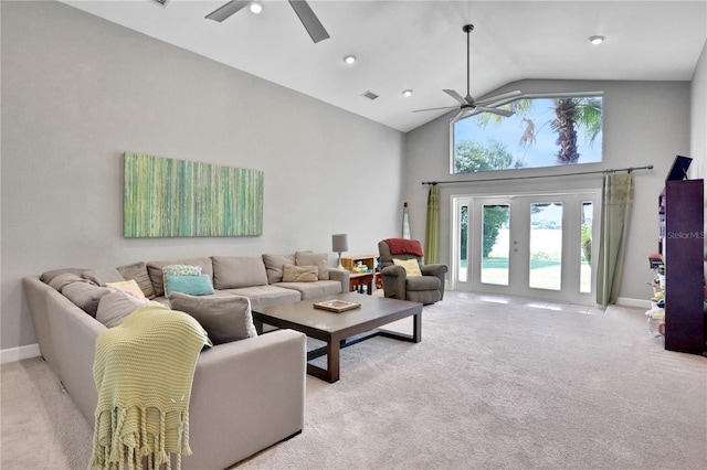 living room featuring lofted ceiling, light colored carpet, ceiling fan, and french doors