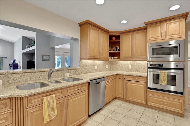 kitchen featuring light stone counters, light tile patterned floors, decorative backsplash, and stainless steel appliances