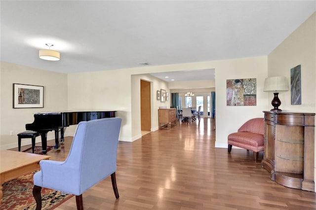 sitting room featuring hardwood / wood-style floors and a notable chandelier