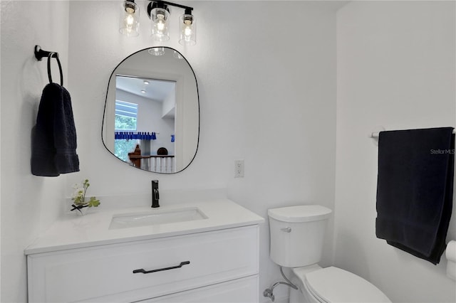 bathroom with toilet and vanity