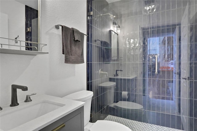 bathroom featuring toilet, vanity, and walk in shower