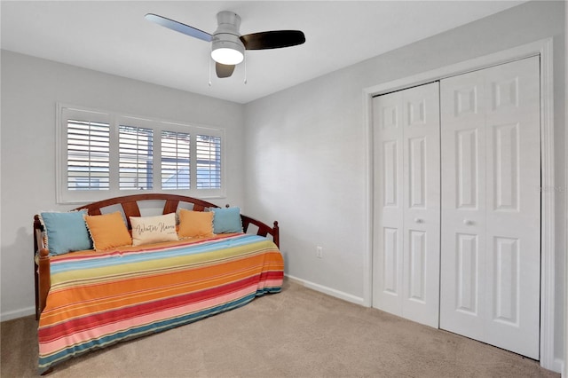 carpeted bedroom with a closet and ceiling fan