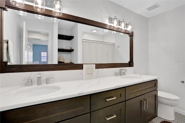 bathroom with vanity, toilet, curtained shower, and tile patterned flooring