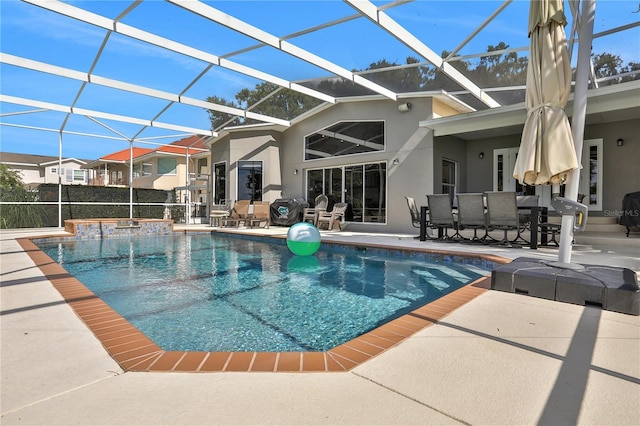 view of swimming pool featuring glass enclosure and a patio area