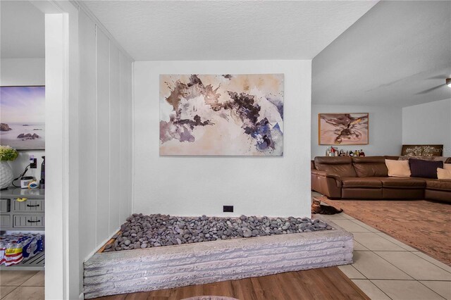 interior space featuring light tile patterned flooring and a textured ceiling