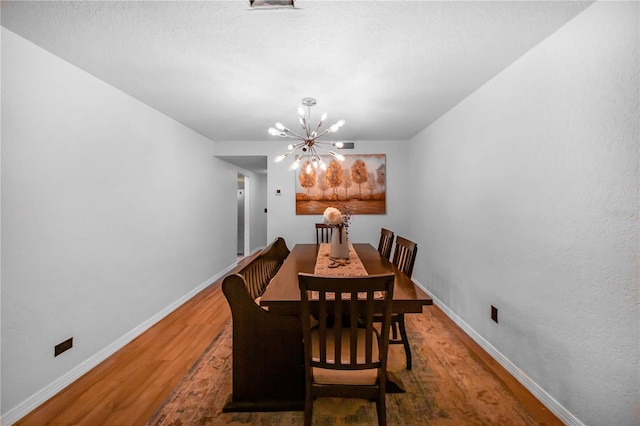 dining room featuring a notable chandelier and hardwood / wood-style floors