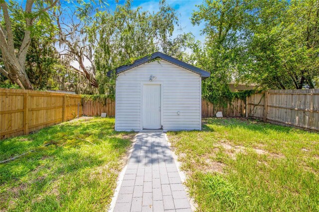 view of outbuilding featuring a lawn