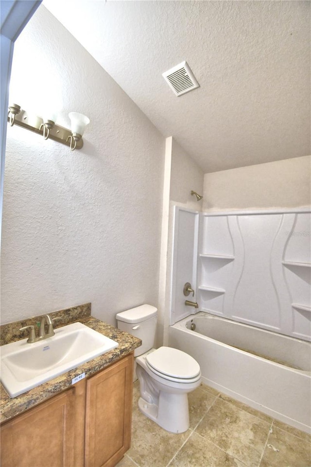 full bathroom featuring a textured ceiling, vanity, shower / bath combination, and toilet