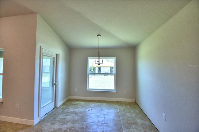 unfurnished dining area featuring vaulted ceiling