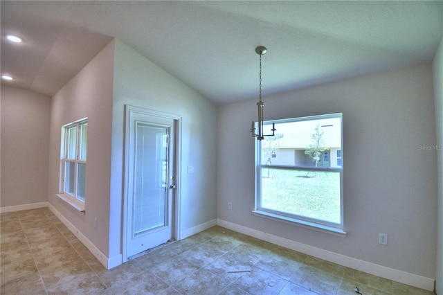 unfurnished dining area with lofted ceiling and a chandelier