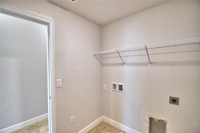 laundry area featuring hookup for an electric dryer, washer hookup, and light tile patterned floors