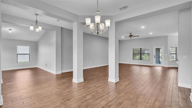 unfurnished dining area with a wealth of natural light, wood finished floors, visible vents, and baseboards