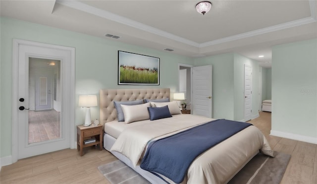 bedroom featuring ornamental molding and a raised ceiling