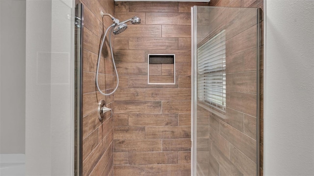 bathroom with tiled shower