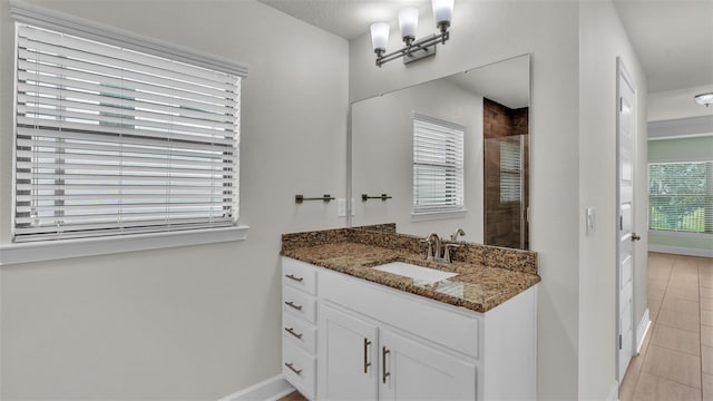 bathroom featuring an enclosed shower, vanity, and tile patterned flooring