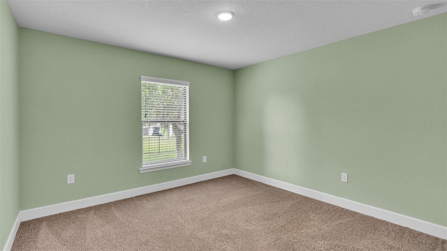 carpeted spare room with baseboards