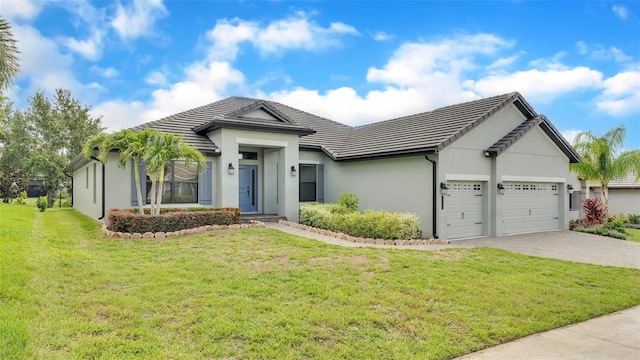 view of front of property with a garage and a front lawn