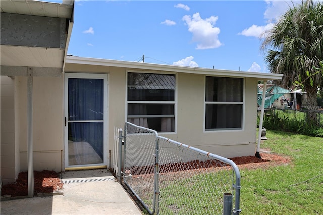 doorway to property with a lawn