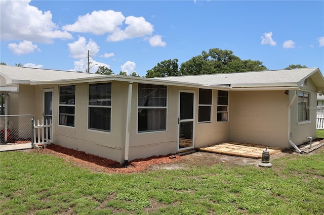 back of property with a lawn