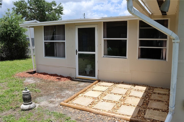 view of exterior entry featuring a patio area