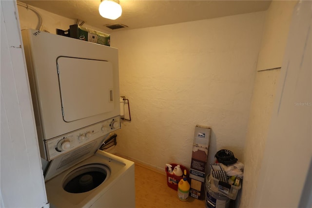 laundry room with stacked washer and clothes dryer