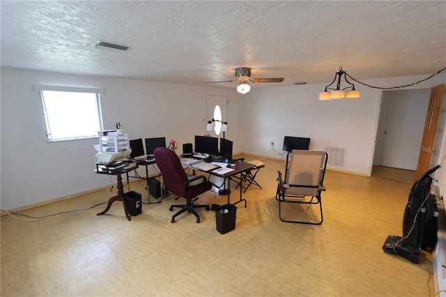 office space featuring ceiling fan, wood-type flooring, and a textured ceiling